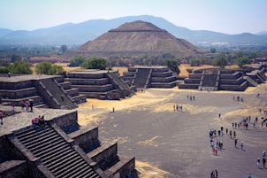 a group of people standing in front of a pyramid