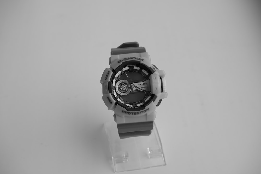 a watch sitting on top of a plastic stand