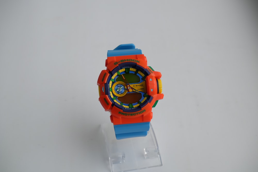 a toy watch sitting on top of a plastic stand