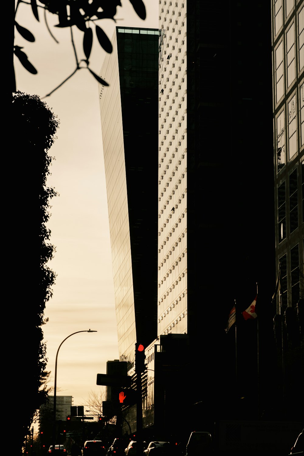 a city street filled with traffic next to tall buildings