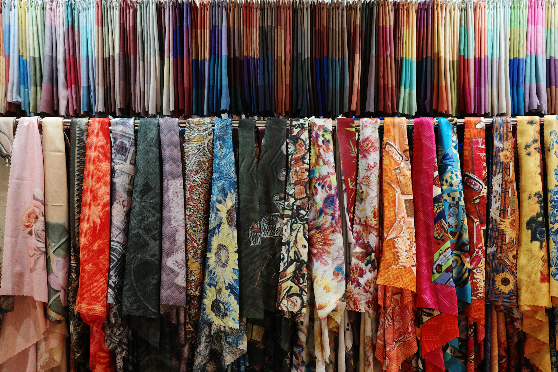 a rack of colorful scarves hanging on a wall