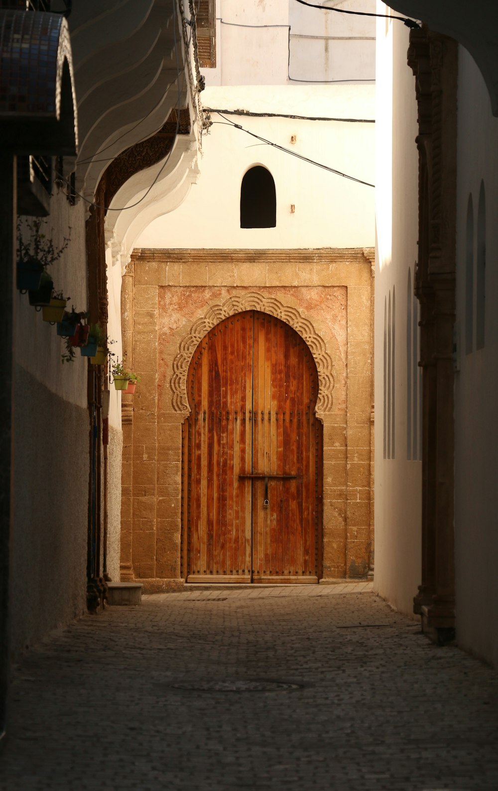 a narrow alleyway with a wooden door