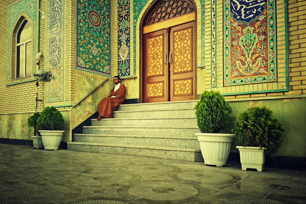 a woman sitting on the steps of a building