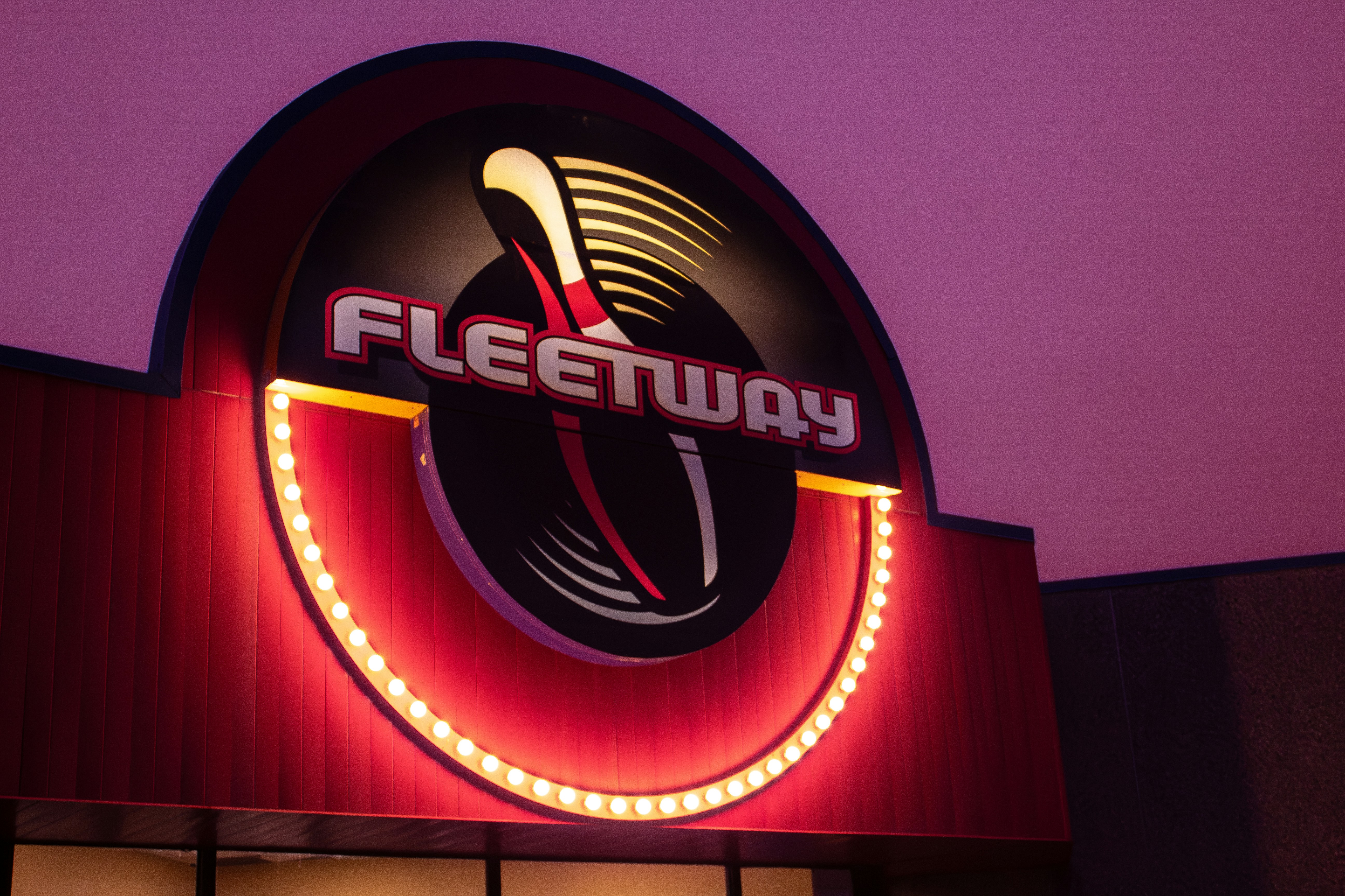 a close up of a neon sign on a building