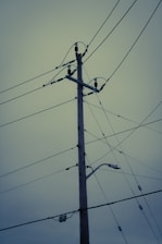 a telephone pole with a bunch of wires attached to it