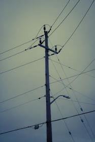 a telephone pole with a bunch of wires attached to it