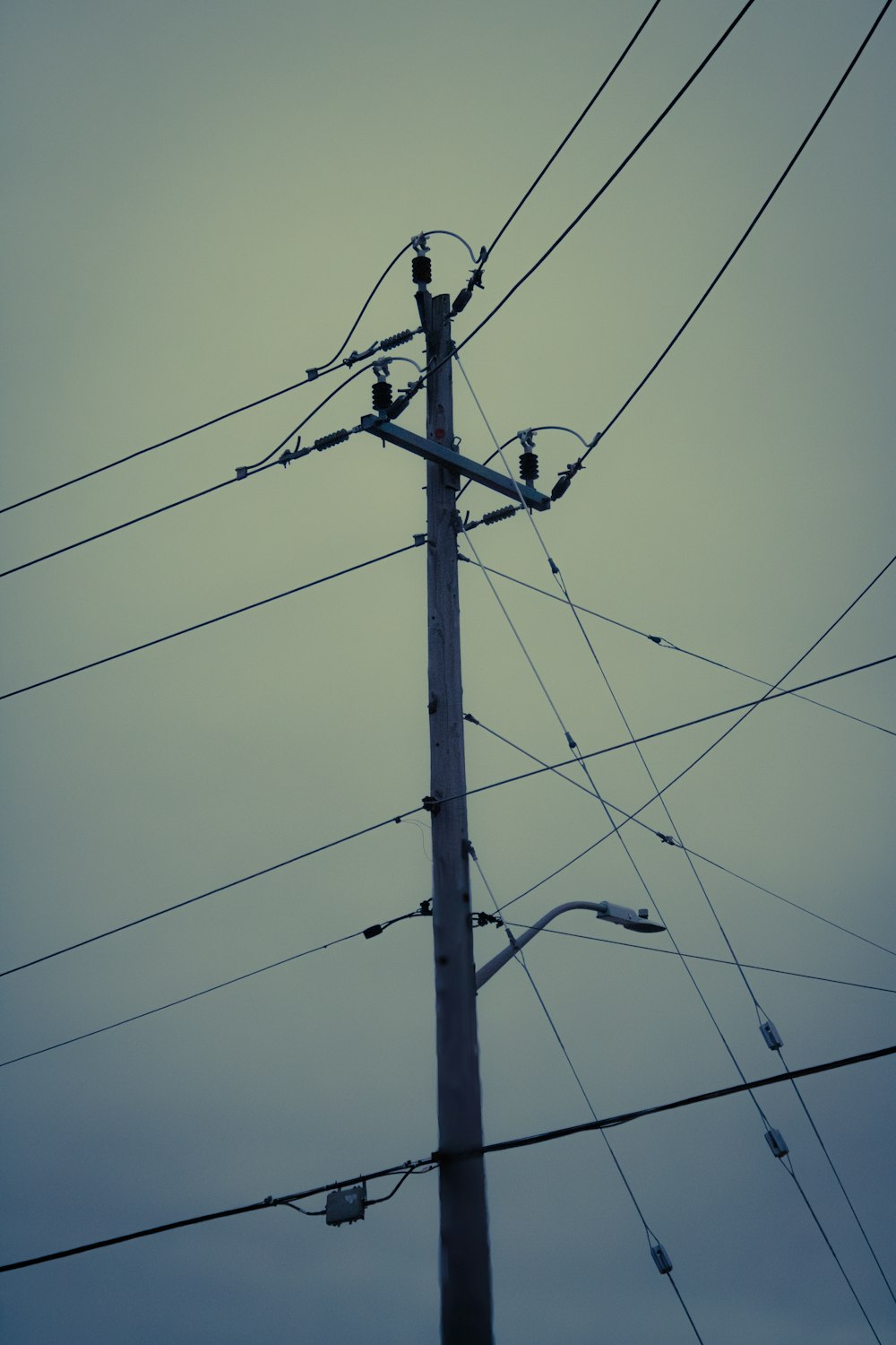 a telephone pole with a bunch of wires attached to it