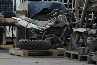 a dirt bike sitting on top of a wooden pallet
