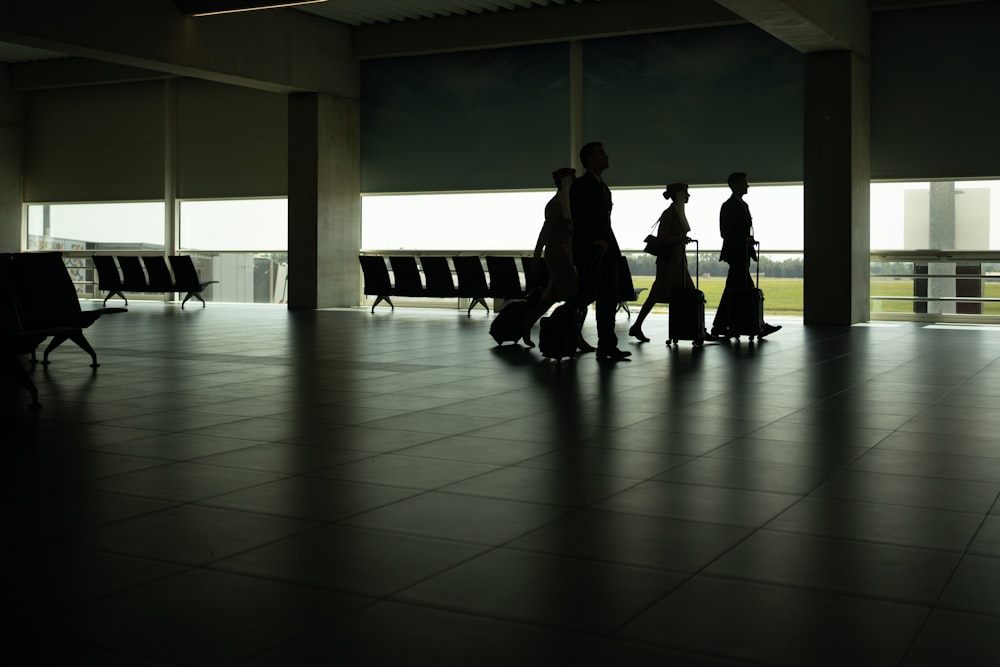 a group of people walking through an airport