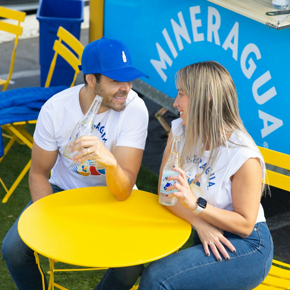 a man and a woman sitting at a yellow table