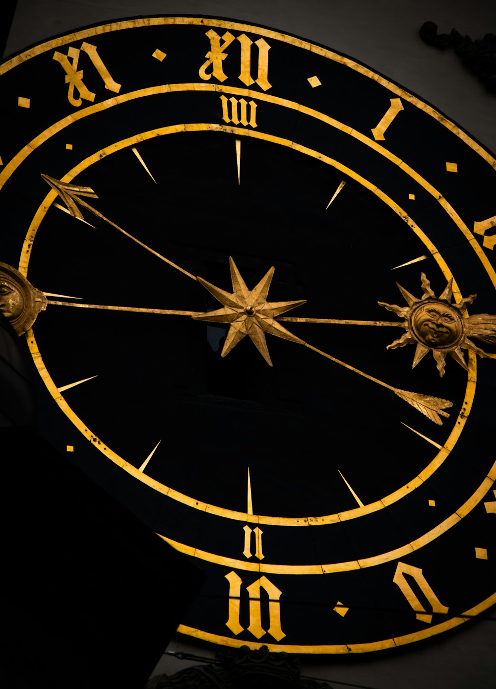 a close up of a gold and black clock