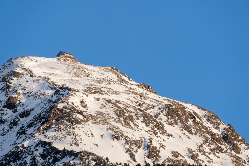 a snow covered mountain with a blue sky in the background