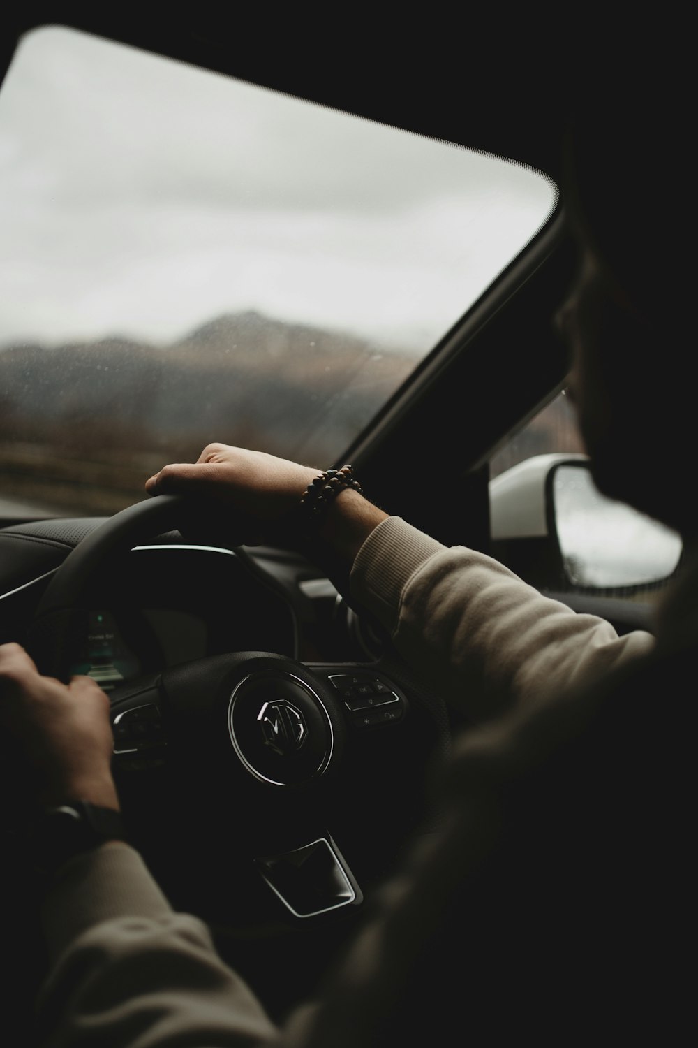 a person driving a car on a cloudy day