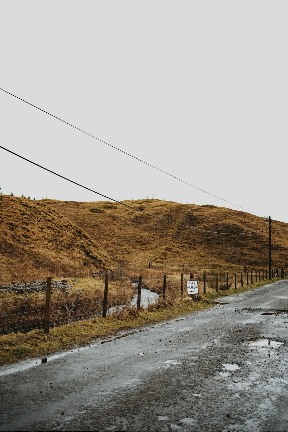 an empty road with a sign on the side of it