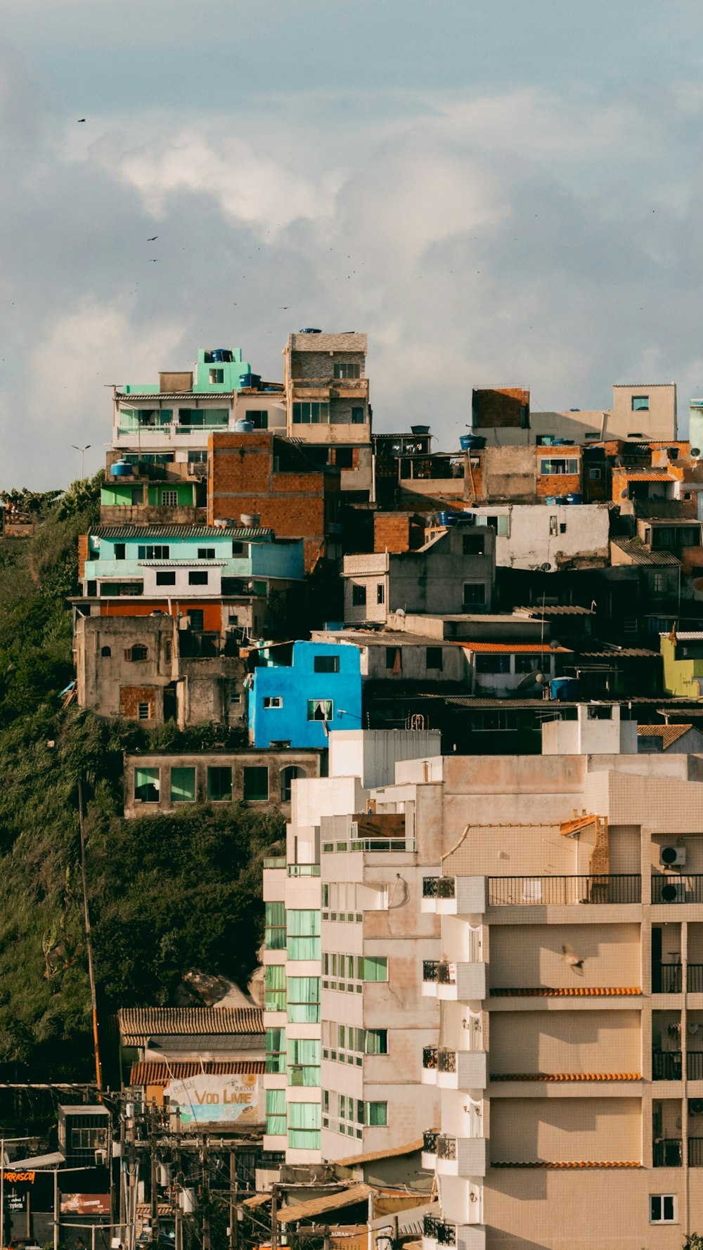 a city with lots of buildings on top of a hill