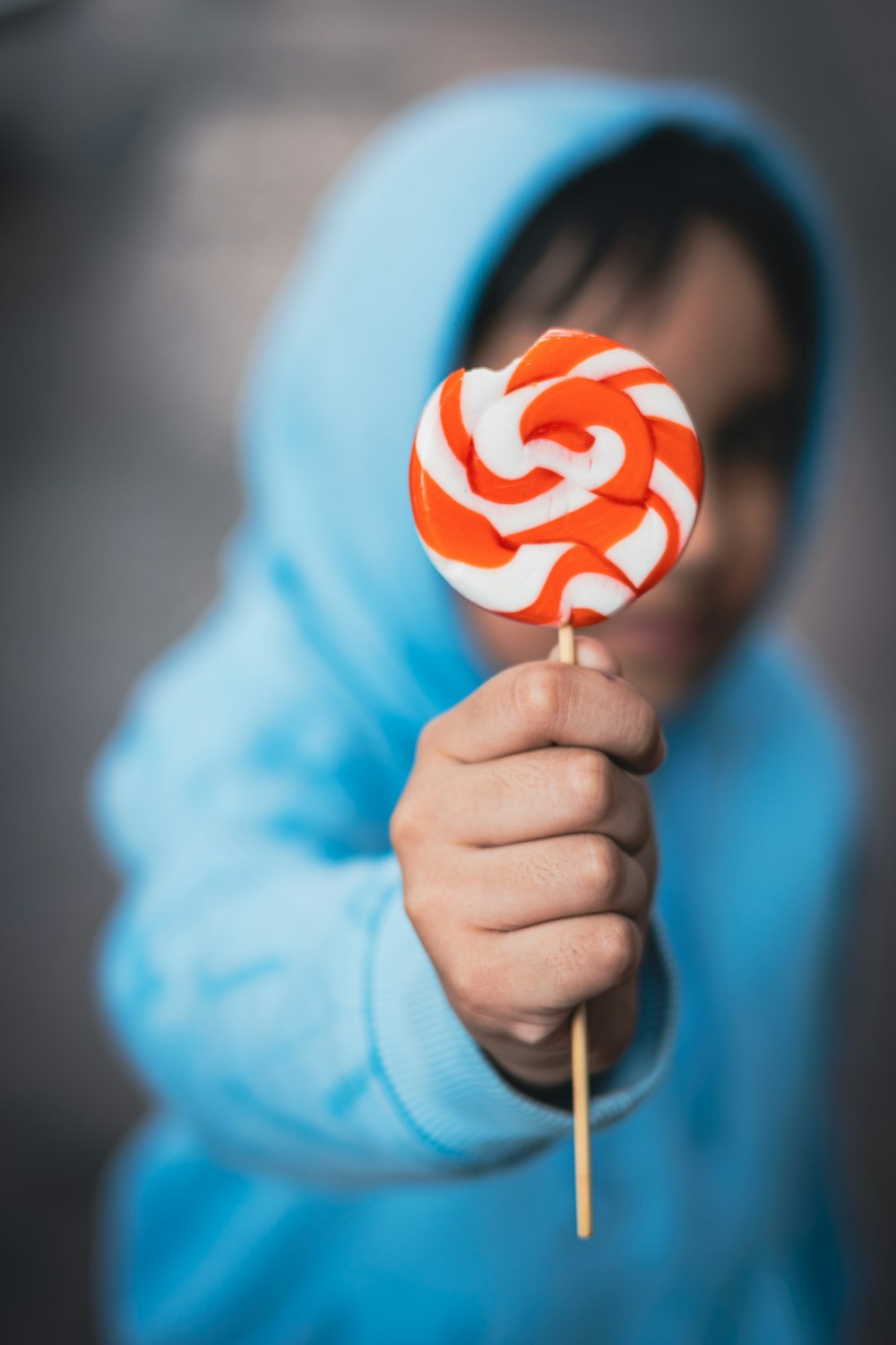 a person holding a lollipop in their hand