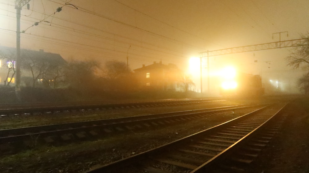 a train traveling down train tracks at night