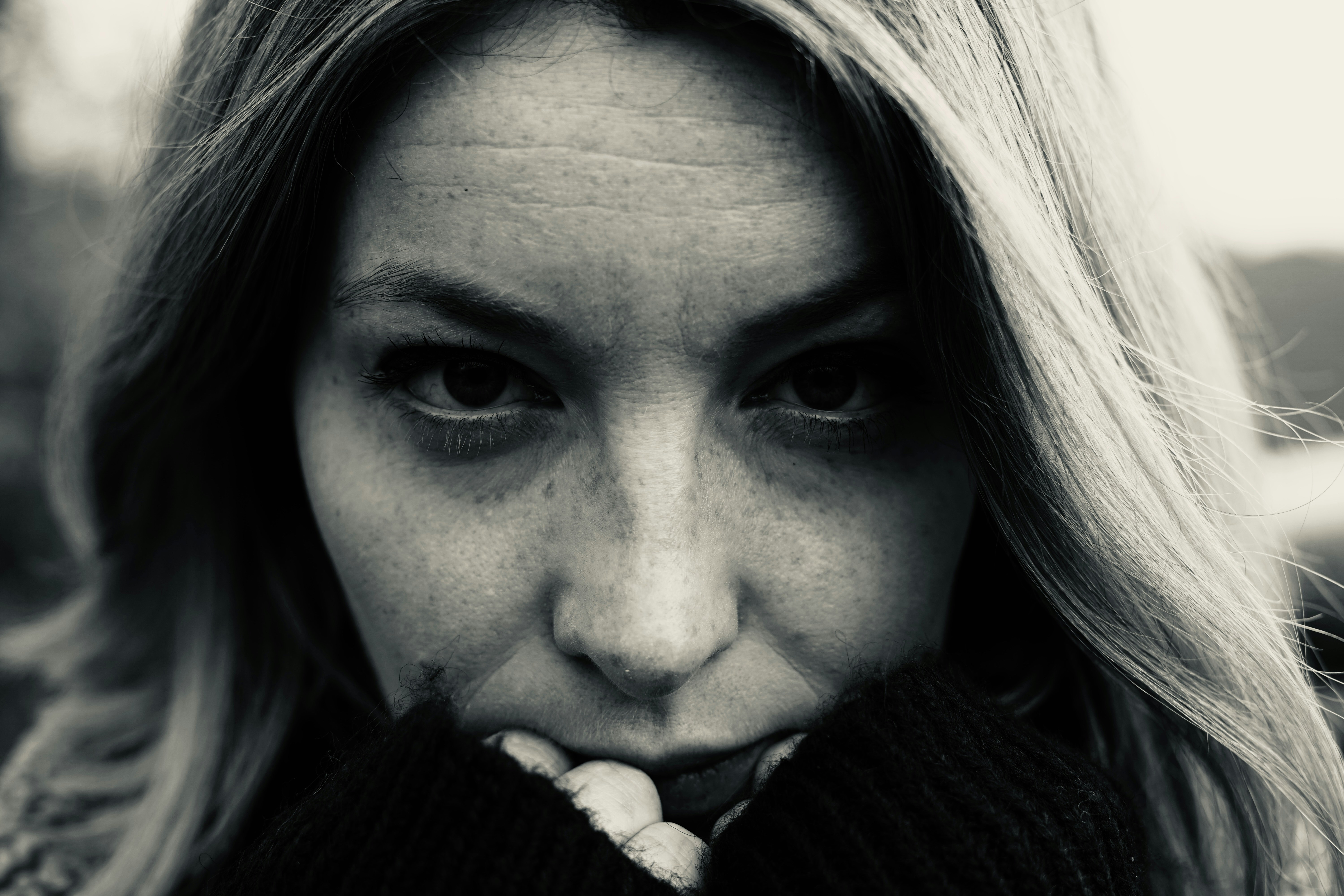a black and white photo of a woman with freckled hair