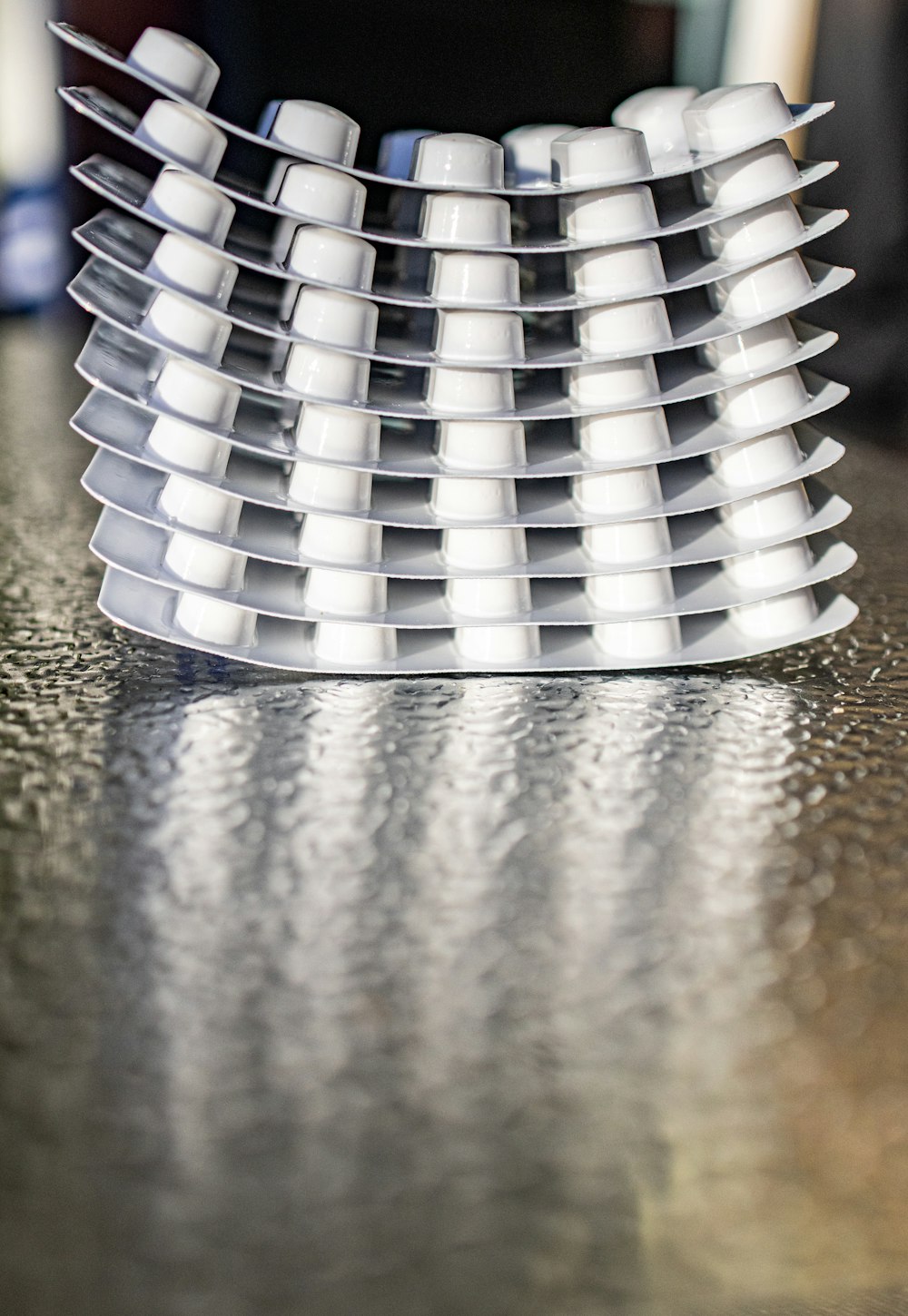 a stack of white cups sitting on top of a table