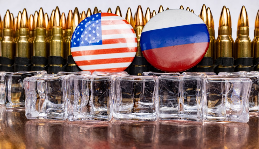 a bunch of bullet casings with flags on them