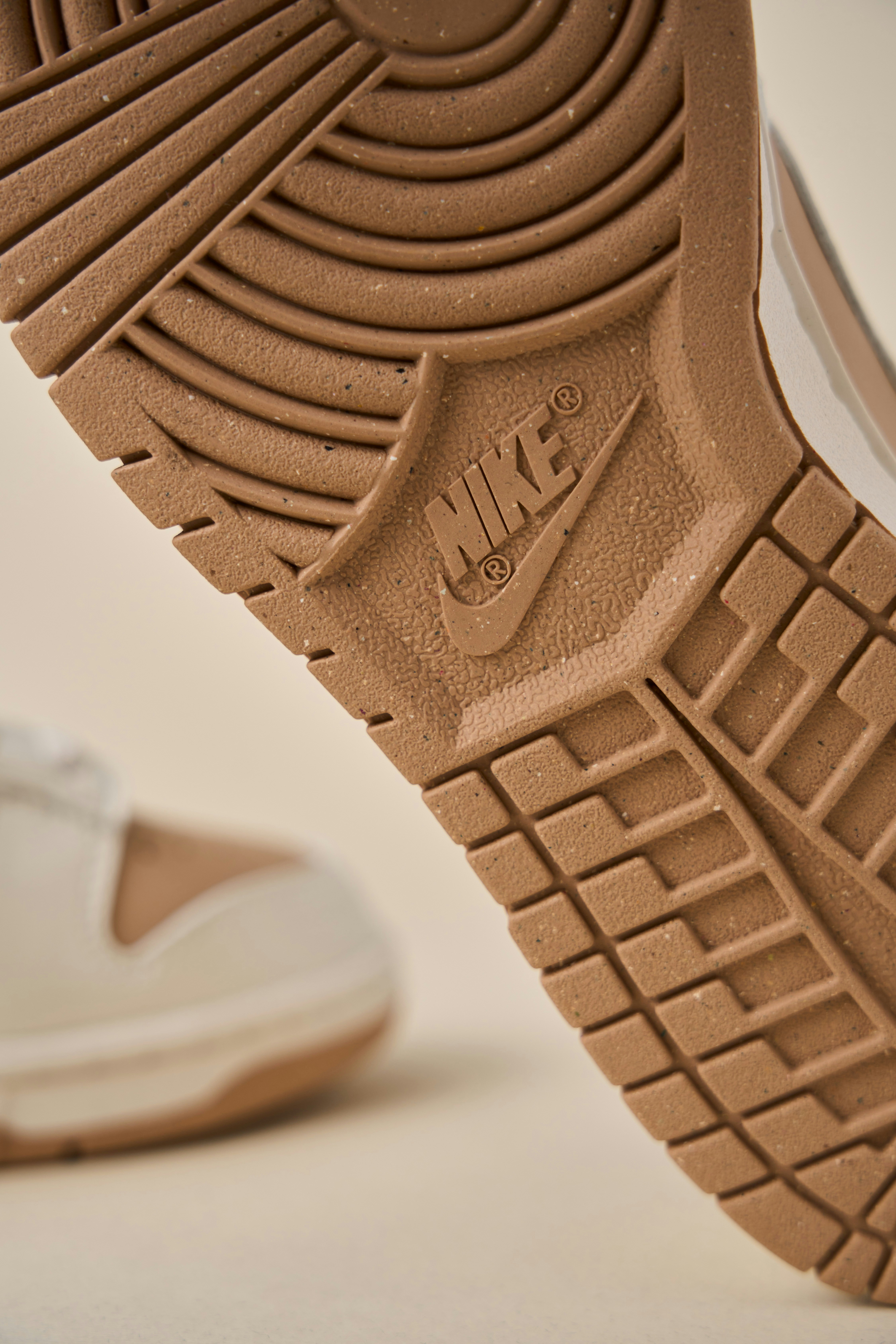 Sneaker sole and heel detail showing rubber tread pattern on clean surface