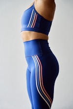 a woman in a blue sports bra top and leggings