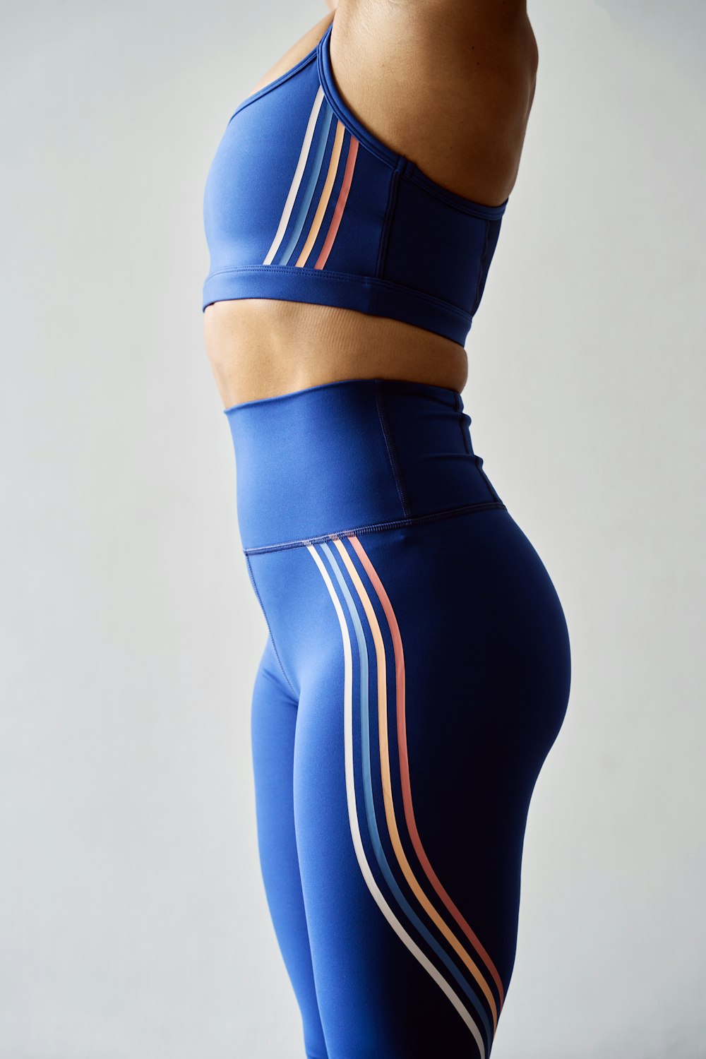 a woman in a blue sports bra top and leggings