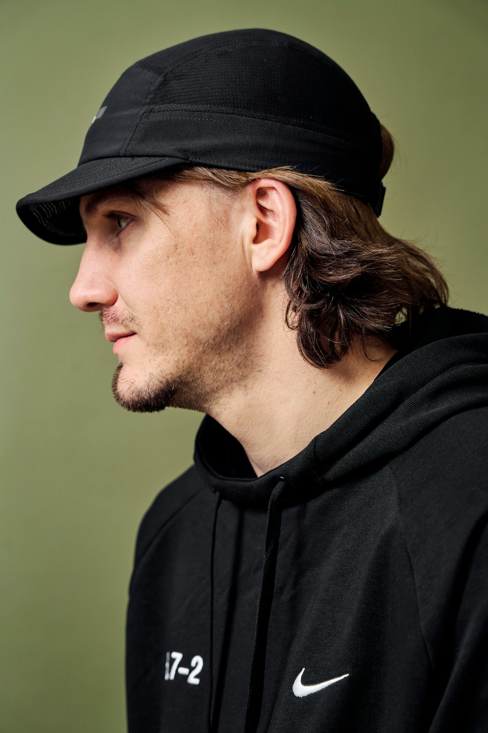 a man wearing a black hat and a black sweatshirt