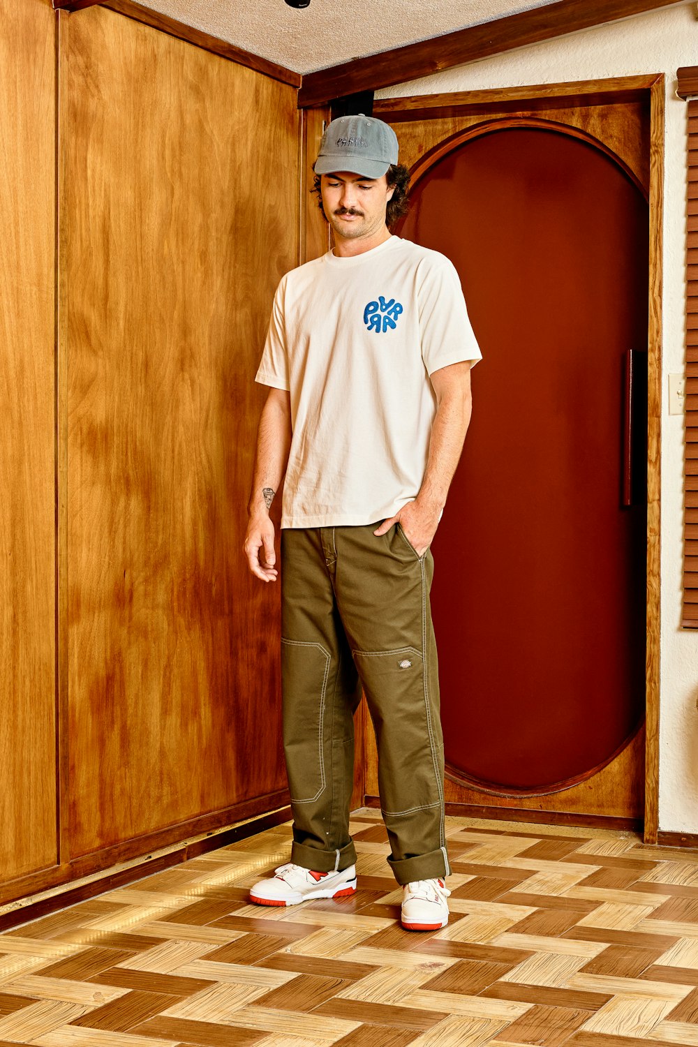 a man standing in front of a wooden door