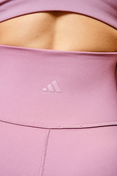 a close up of a person wearing a pink top