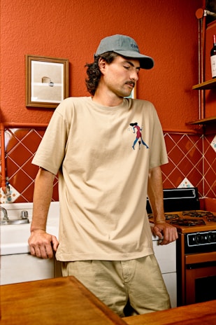 a man standing in a kitchen next to a counter