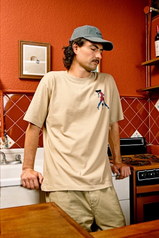 a man standing in a kitchen next to a counter