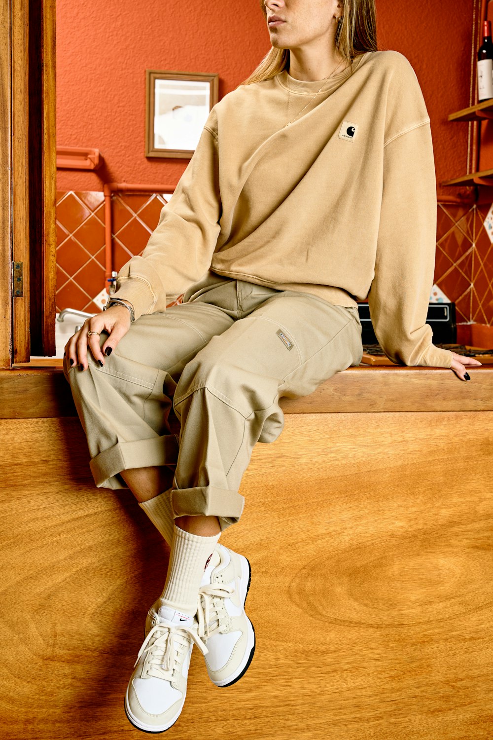 a woman sitting on top of a wooden counter