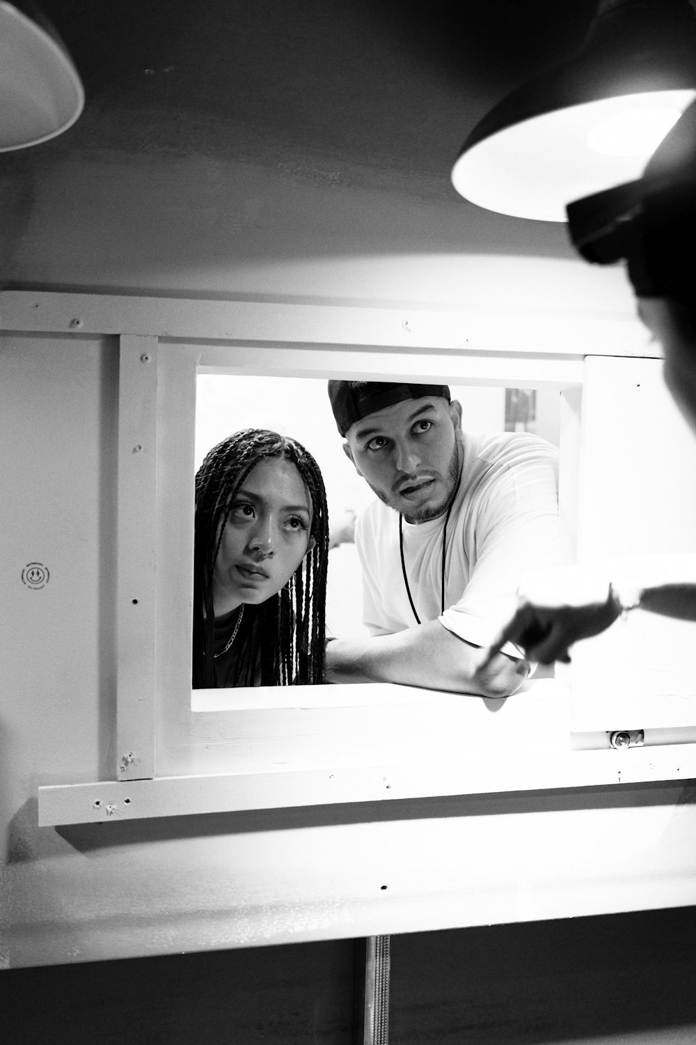 a man standing next to a woman in front of a mirror