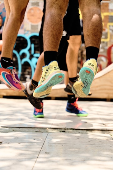a couple of people that are standing on a skateboard