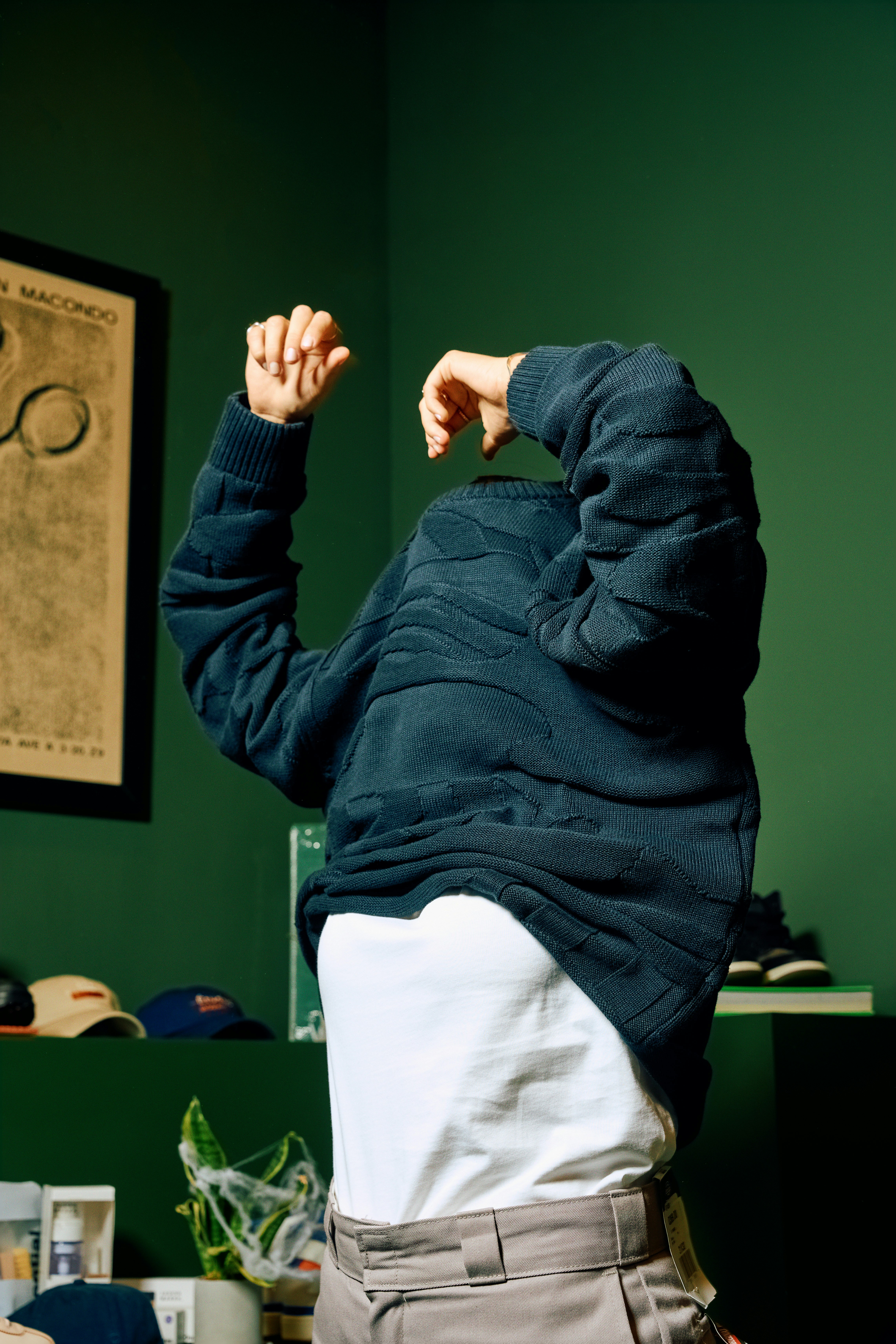 Older adult pulling a shirt over his head while getting dressed
