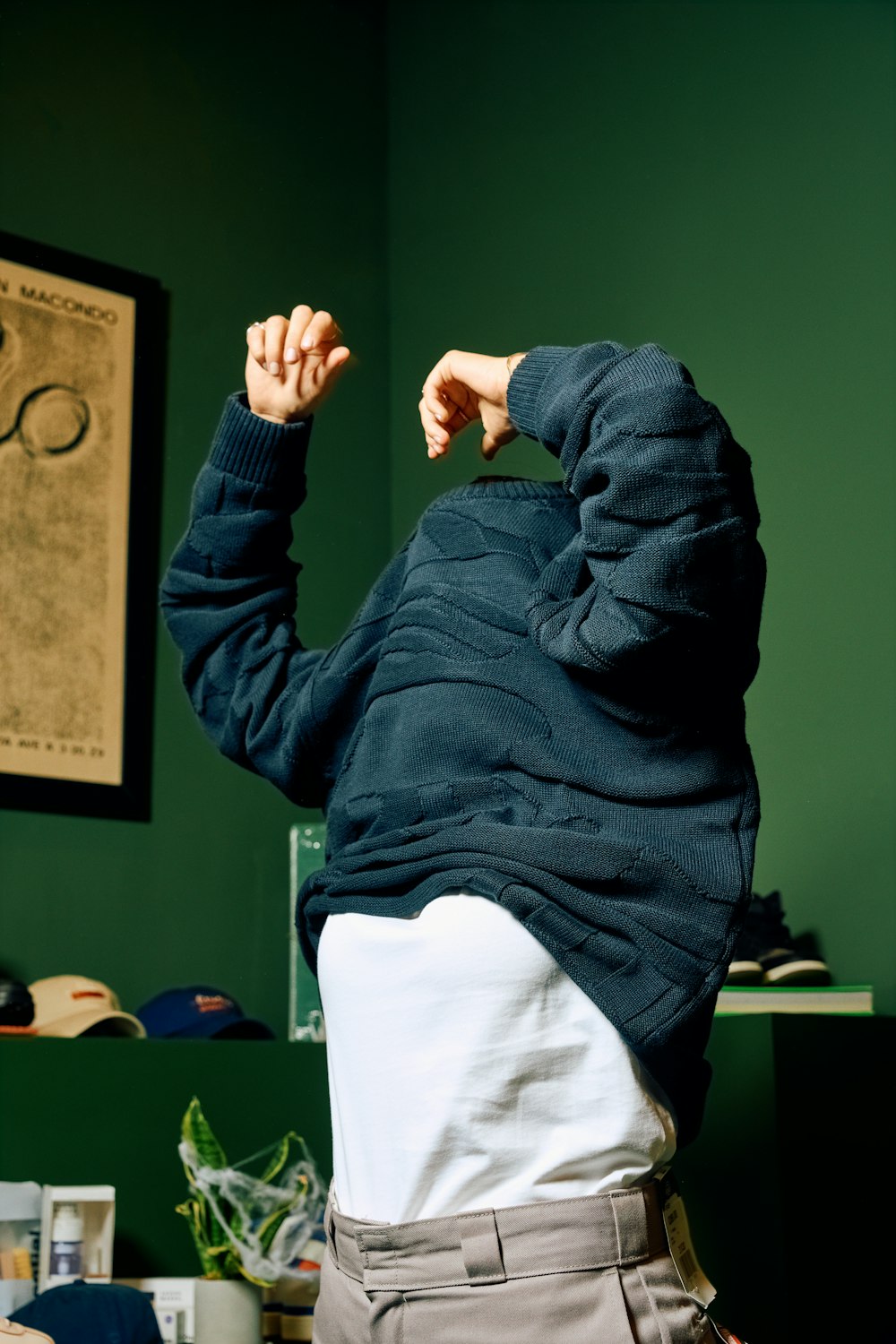 a man standing in a room with his hands in the air