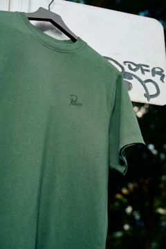 a green shirt hanging on a clothes line