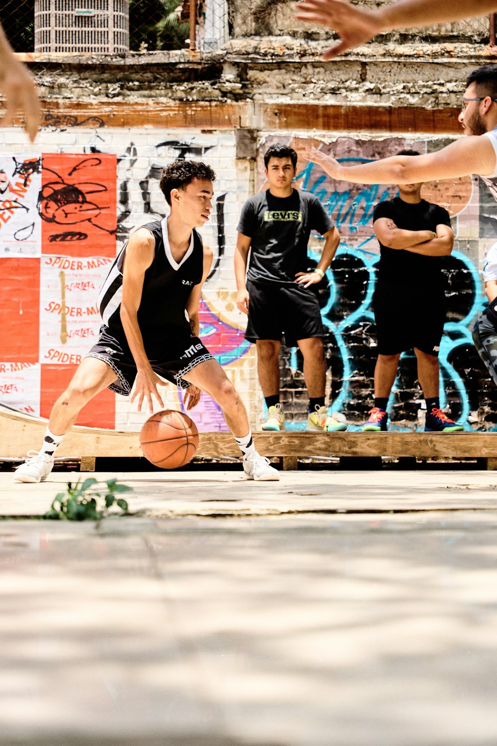 a group of young men playing a game of basketball