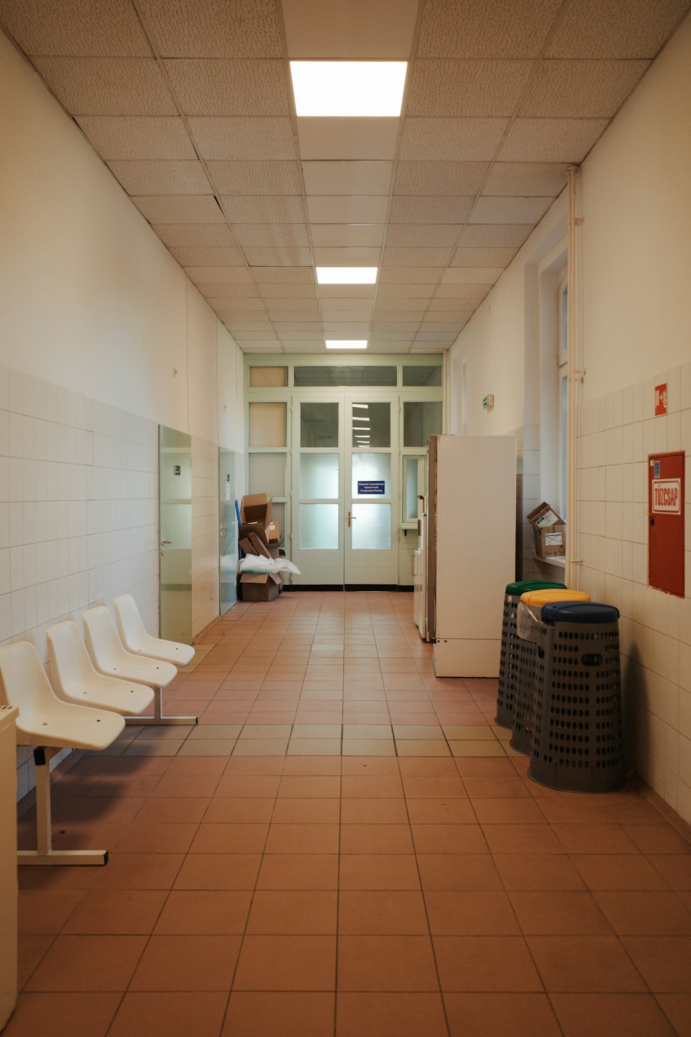 a long hallway with a bunch of chairs in it