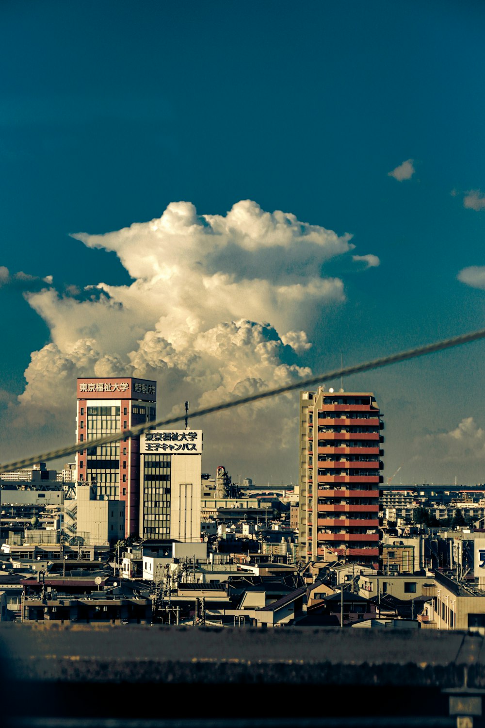 a view of a city with tall buildings under a cloudy sky