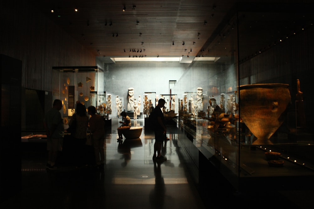 a group of people standing around a museum