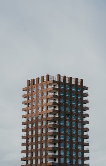 a tall brown building with lots of windows