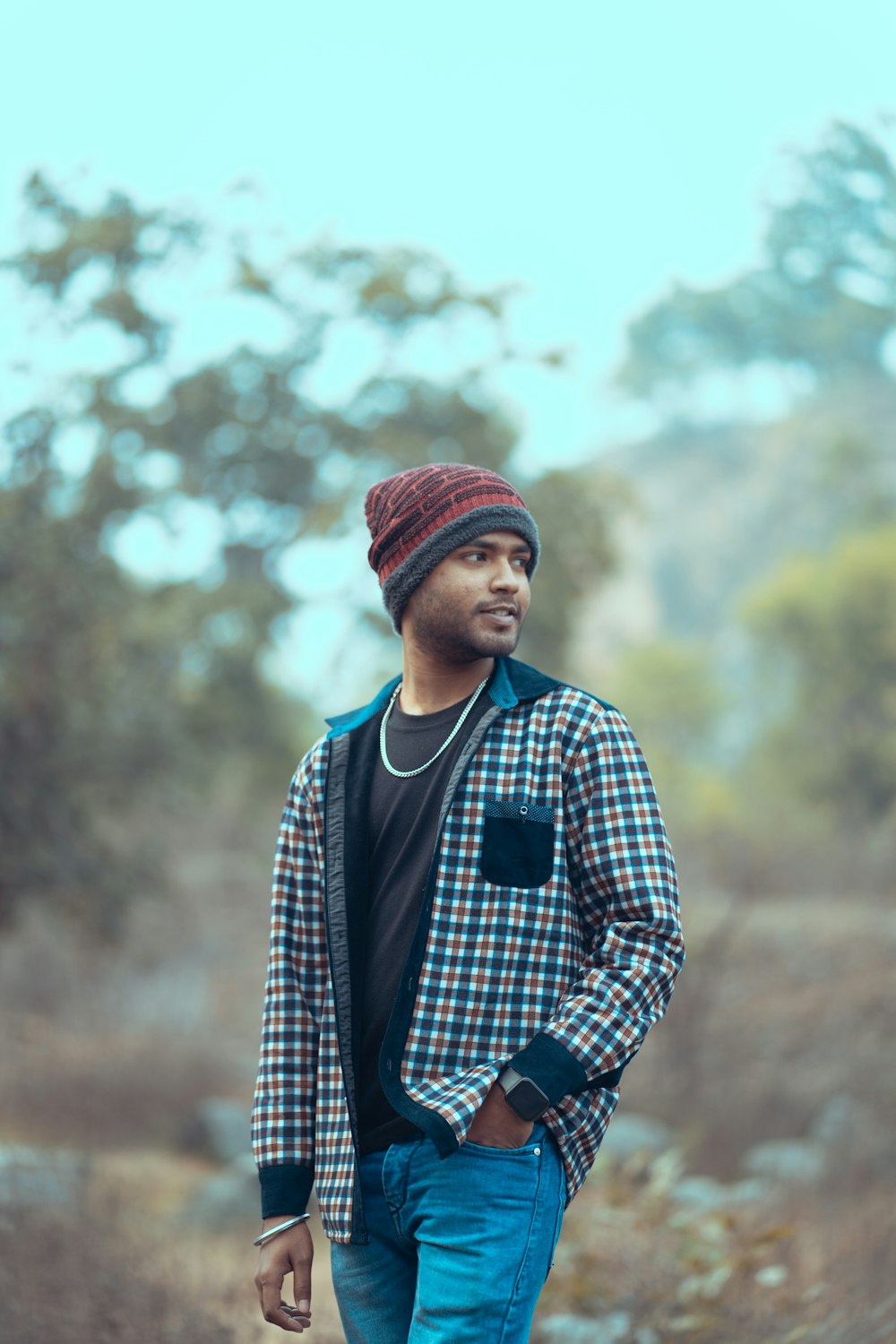 a man in a plaid jacket and a beanie