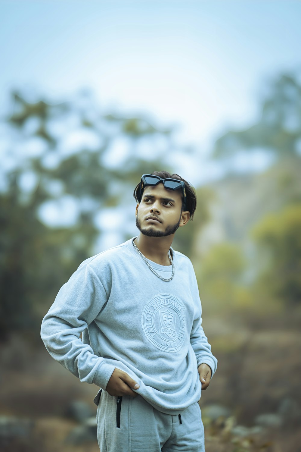 a man standing in front of a forest