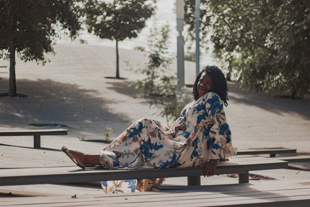 a woman sitting on a bench in a park