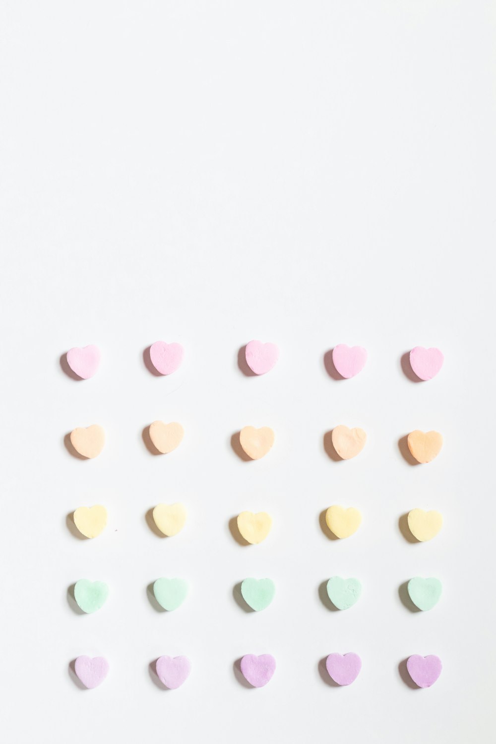 a group of pastel hearts on a white background