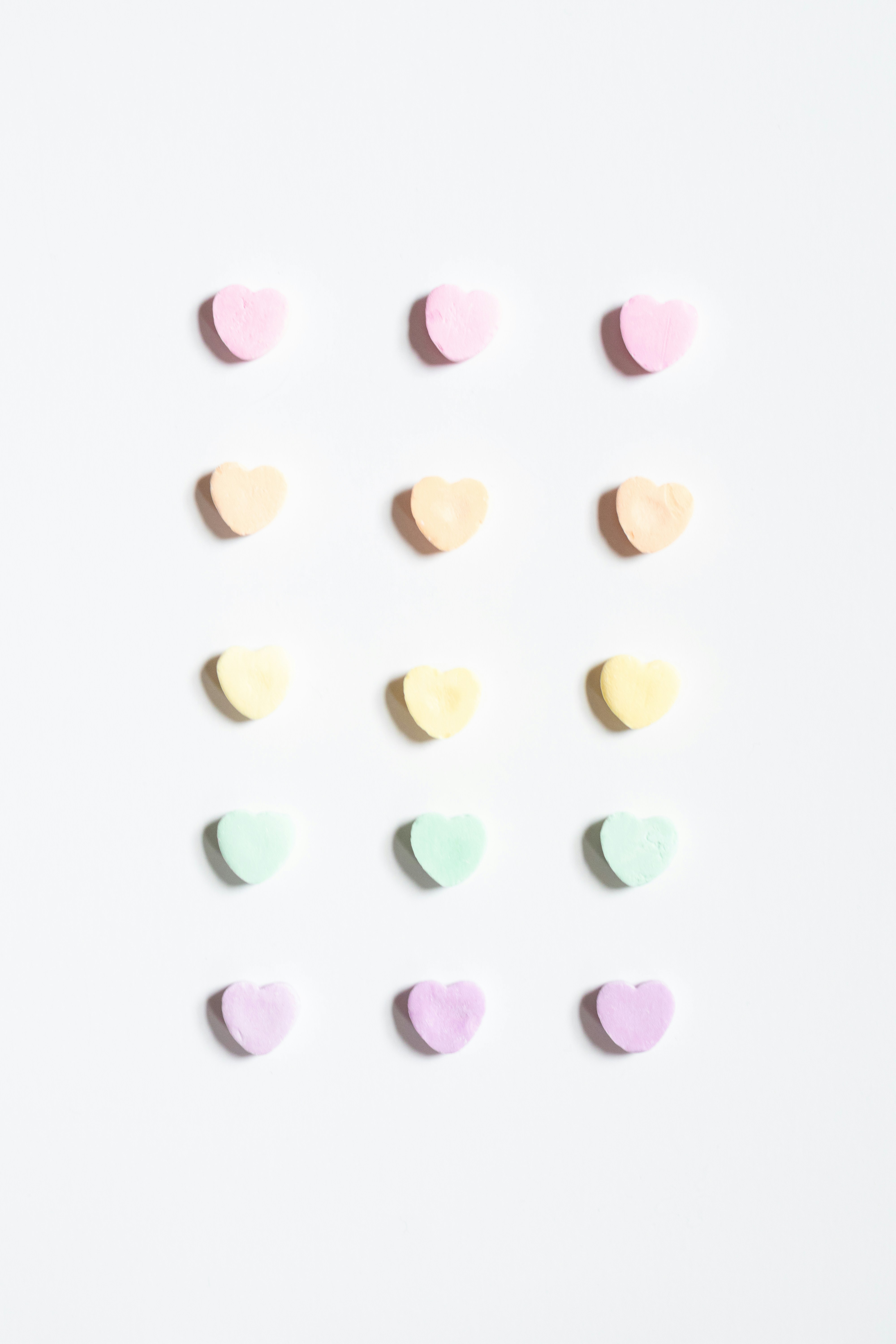 a group of pastel hearts on a white background