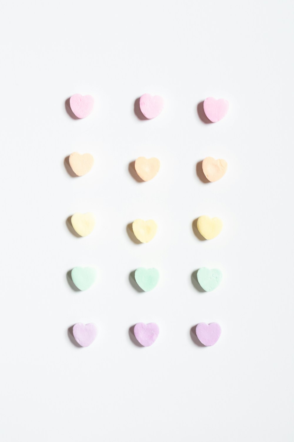a group of pastel hearts on a white background