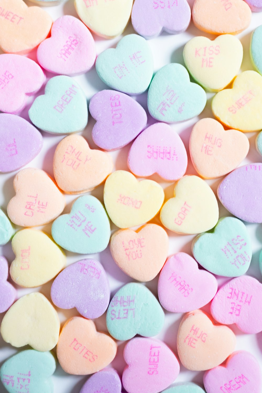 a pile of conversation hearts on a table